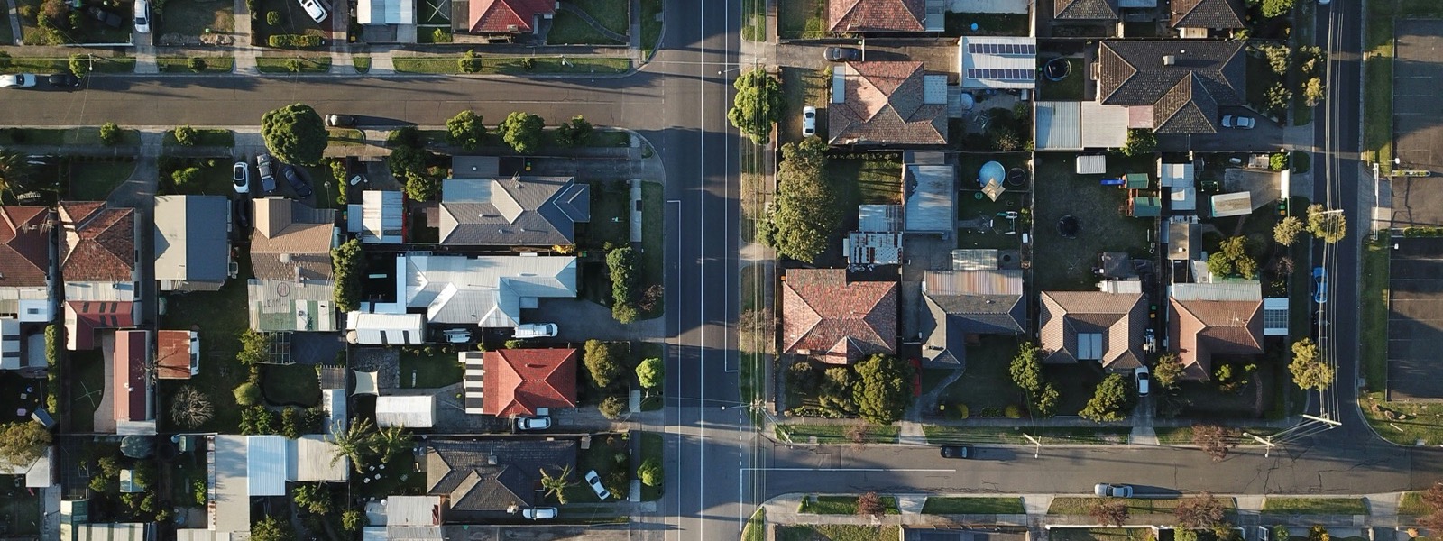 Aerial view of a suburban neighborhood street lined with houses